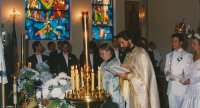 Fr. Oleg marries the young couples, admonishes them for sincerity and righteousness in married life