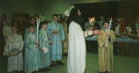Fr. Oleg in the midst of boys during the Easter sermon to parishioners